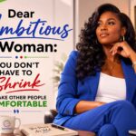 A motivational graphic featuring a confident Black American woman in a royal blue business suit sitting in a modern office setting. The design uses the Connect brand colors—blue, red, and green—and displays the empowering quote, “Dear Ambitious Woman: You Don’t Have to Shrink to Make Other People Comfortable.” The woman is portrayed with a poised and self-assured expression, symbolizing confidence, leadership, and personal growth. Decorative elements, including branded accents, books, and a coffee mug, reinforce themes of empowerment and professional success.